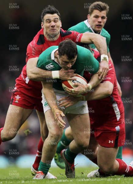 140315 - Wales v Ireland - RBS 6 Nations - Peter OÕMahony of Ireland is tackled by Mike Phillips and Aaron Jarvis of Wales