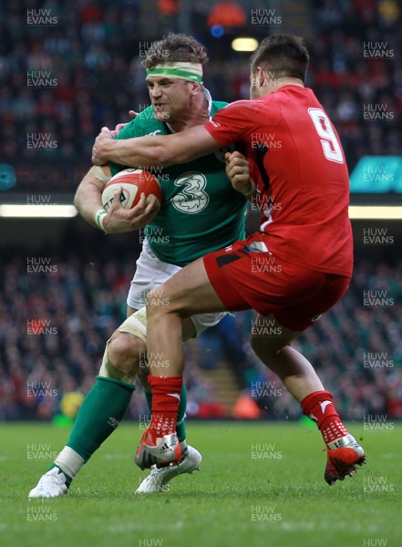 140315 - Wales v Ireland - RBS 6 Nations - Jamie Heaslip of Ireland is tackled by Rhys Webb of Wales