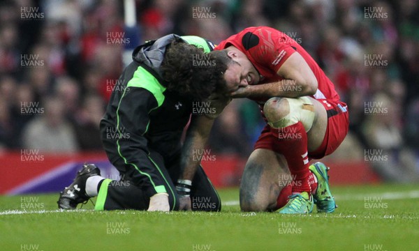 140315 - Wales v Ireland - RBS 6 Nations - Jamie Roberts of Wales is seen to by a medic