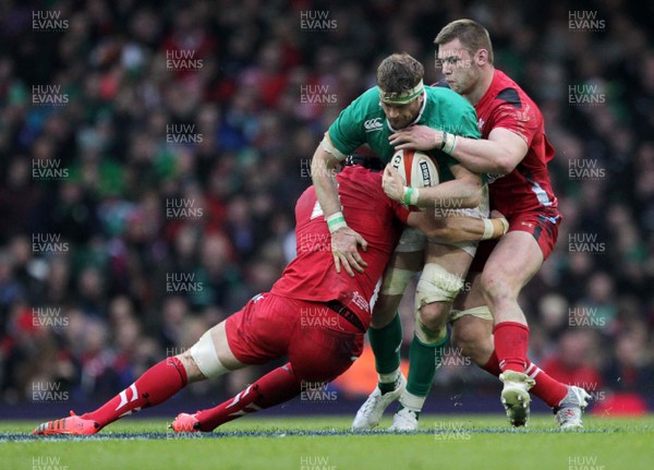 140315 - Wales v Ireland - RBS 6 Nations - Jamie Heaslip of Ireland is tackled by Luke Charteris and Dan Lydiate of Wales