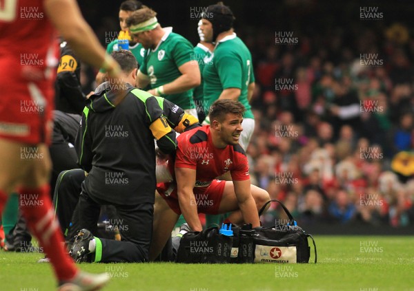 140315 - Wales v Ireland - RBS 6 Nations -Rhys Webb of Wales struggles with an injury