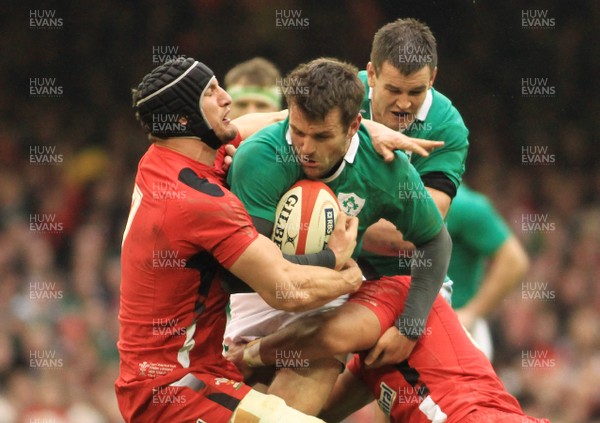 140315 - Wales v Ireland - RBS 6 Nations -Jarad Payne of Ireland is tackled by Sam Warburton(L) and Taulupe faletau of Wales