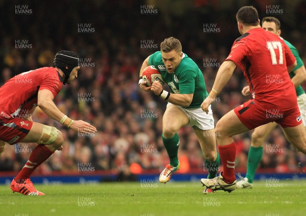 140315 - Wales v Ireland - RBS 6 Nations -Ian Madigan of Ireland takes on Luke Charteris of Wales