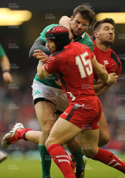 140315 - Wales v Ireland, RBS 6 Nations 2015 - Jared Payne of Ireland takes on Rhys Webb of Wales and Leigh Halfpenny of Wales