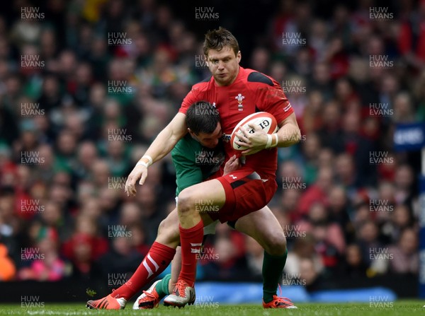 140315 - Wales v Ireland - RBS Six Nations - Dan Biggar of Wales is tackled by Johnny Sexton of Ireland