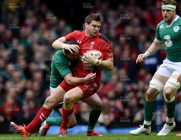 140315 - Wales v Ireland - RBS Six Nations - Dan Biggar of Wales is tackled by Johnny Sexton of Ireland