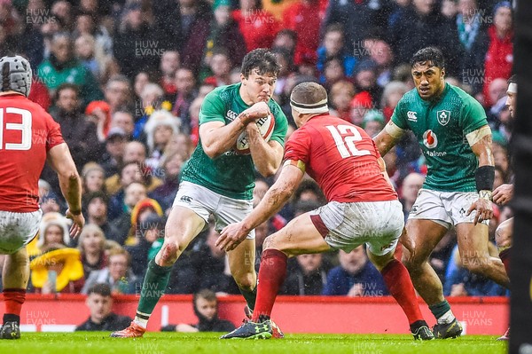 160319 - Wales v Ireland - Guinness Six Nations - Jacob Stockdale of Ireland tries to pass Hadleigh Parkes of Wales 