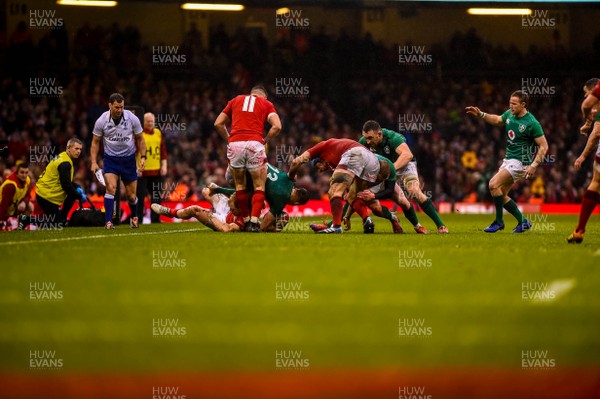 160319 - Wales v Ireland - Guinness Six Nations - Garry Ringrose of Ireland is tackled by Josh Adams and Aled Davies of Wales
