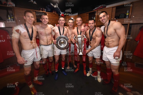 160319 - Wales v Ireland - Guinness Six Nations - Liam Williams, Hadleigh Parkes, Josh Adams, Jonathan Davies, Gareth Anscombe, Gareth Davies and George North of Wales with the trophy in the dressing room