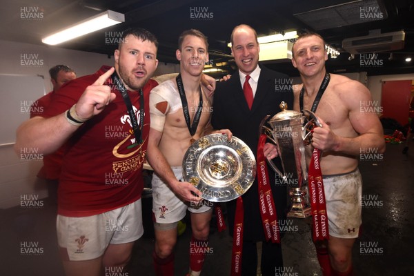 160319 - Wales v Ireland - Guinness Six Nations - Rob Evans, Liam Williams and Hadleigh Parkes of Wales with Prince William with the trophy in the dressing room