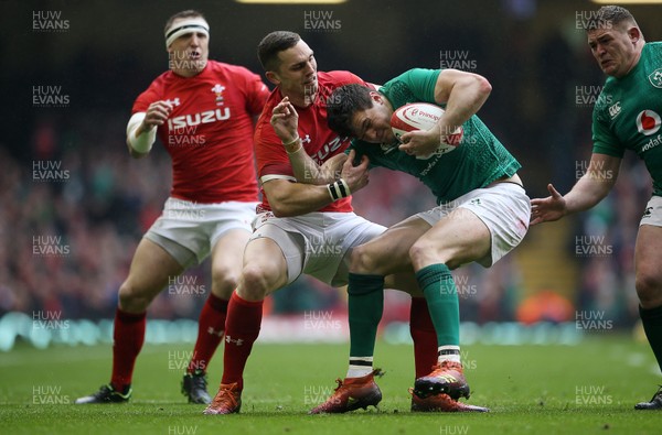 160319 - Wales v Ireland - Guinness 6 Nations Championship - George North of Wales pulls Jacob Stockdale of Ireland into touch