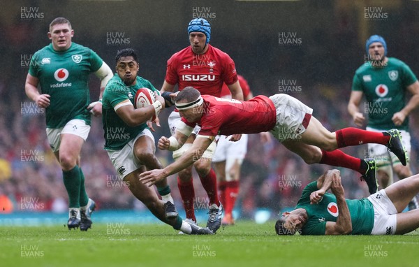 160319 - Wales v Ireland, Guinness Six Nations Championship 2019 - Hadleigh Parkes of Wales tries to catch Bundee Aki of Ireland