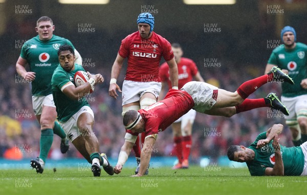 160319 - Wales v Ireland, Guinness Six Nations Championship 2019 - Hadleigh Parkes of Wales tries to catch Bundee Aki of Ireland