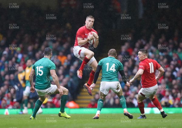 160319 - Wales v Ireland, Guinness Six Nations Championship 2019 - Gareth Anscombe of Wales takes the high ball as Rob Kearney of Ireland and Keith Earls of Ireland  look on