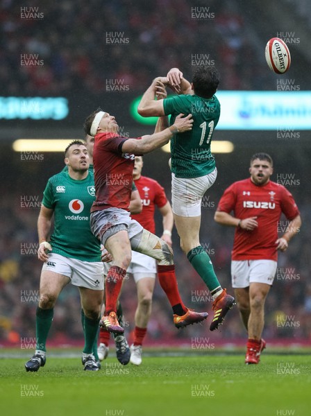 160319 - Wales v Ireland, Guinness Six Nations Championship 2019 - Dan Biggar of Wales  and Jacob Stockdale of Ireland compete for the ball