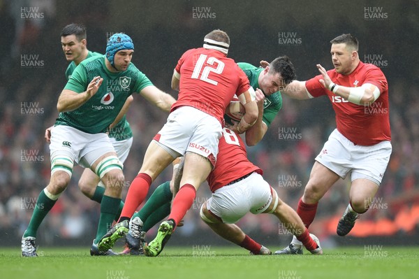 160319 - Wales v Ireland - Guinness Six Nations - Garry Ringrose of Ireland  is tackled by Ross Moriarty of Wales  and Hadleigh Parkes of Wales 