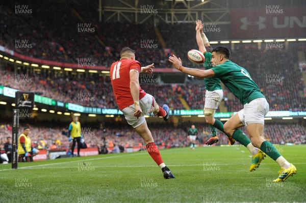 160319 - Wales v Ireland - Guinness Six Nations - Josh Adams of Wales clears under pressure from Conor Murray of Ireland 