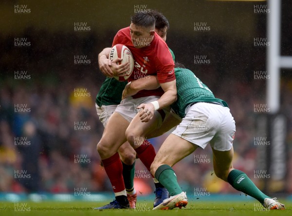 160319 - Wales v Ireland - Guinness Six Nations -  Josh Adams of Wales is tackled by Jacob Stockdale and Garry Ringrose of Ireland 