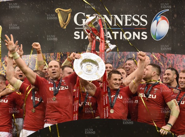 160319 - Wales v Ireland - Guinness Six Nations -  Alun Wyn Jones lifts the Six Nations Championship trophy and Jonathan Davies raises the Triple Crown