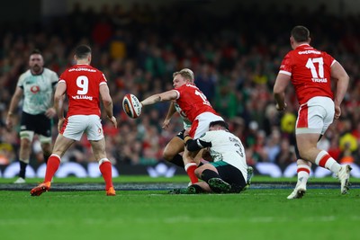 220225 - Wales v Ireland - Guinness Six Nations - Blair Murray of Wales offloads to teammate Tomos Williams as he is tackled by Thomas Clarkson of Ireland