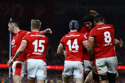 220225 - Wales v Ireland - Guinness Six Nations - Tom Rogers of Wales celebrates scoring his team's second try with teammates