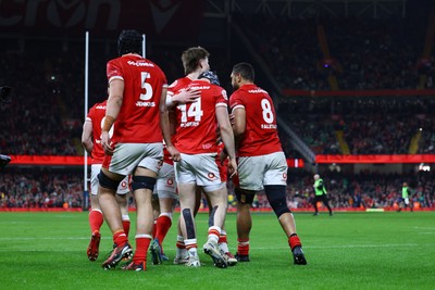 220225 - Wales v Ireland - Guinness Six Nations - Tom Rogers of Wales celebrates scoring his team's second try with teammates