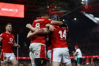 220225 - Wales v Ireland - Guinness Six Nations - Tom Rogers of Wales celebrates scoring his team's second try with teammates