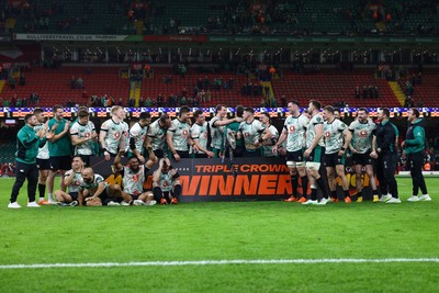 220225 - Wales v Ireland - Guinness Six Nations - The Irish team celebrate with the Triple Crown trophy