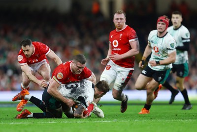 220225 - Wales v Ireland - Guinness Six Nations - Will Rowlands of Wales tackles Garry Ringrose of Ireland 