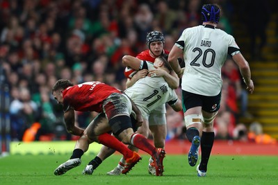 220225 - Wales v Ireland - Guinness Six Nations - James Lowe of Ireland is tackled by Tom Rogers and Max Llewellyn of Wales as Ryan Baird of Ireland looks on