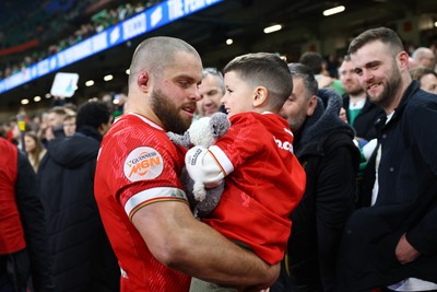 220225 - Wales v Ireland - Guinness Six Nations - Holding his son, Nicky Smith of Wales interacts with the crowd following the game