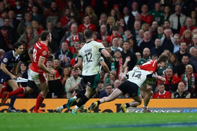 220225 - Wales v Ireland - Guinness Six Nations - Ellis Mee of Wales is tackled by Mack Hansen of Ireland as he scores a try that is later disallowed