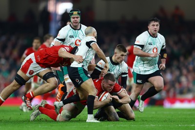 220225 - Wales v Ireland - Guinness Six Nations - Will Rowlands of Wales is tackled by Jamison Gibson-Park and Sam Prendergast of Ireland