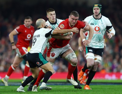 220225 - Wales v Ireland - Guinness Six Nations - Will Rowlands of Wales is tackled by Sam Prendergast and Jamison Gibson-Park of Ireland 