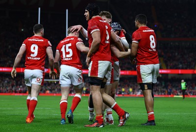 220225 - Wales v Ireland - Guinness Six Nations -Dafydd Jenkins of Wales celebrates with teammates Ellis Mee and Tom Rogers of Wales after Tom Rogers (obscured) scored the team's second try 