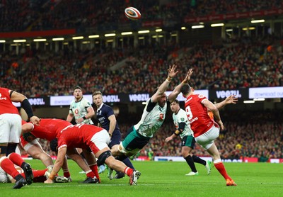 220225 - Wales v Ireland - Guinness Six Nations - Jack Conan  of Ireland attempts to charge down as Tomos Williams of Wales box kicks the ball clear from the maul