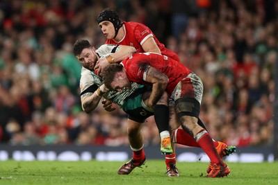 220225 - Wales v Ireland - Guinness 6 Nations Championship - Robbie Henshaw of Ireland is tackled by Max Llewellyn of Wales 