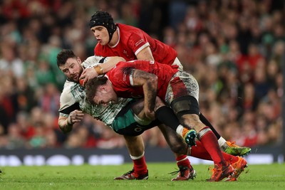 220225 - Wales v Ireland - Guinness 6 Nations Championship - Robbie Henshaw of Ireland is tackled by Max Llewellyn of Wales 