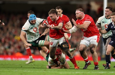 220225 - Wales v Ireland - Guinness 6 Nations Championship - Max Llewellyn of Wales is tackled by Peter O�Mahony and Tadhg Beirne of Ireland 