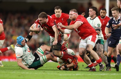 220225 - Wales v Ireland - Guinness 6 Nations Championship - Max Llewellyn of Wales is tackled by Peter O�Mahony and Tadhg Beirne of Ireland 