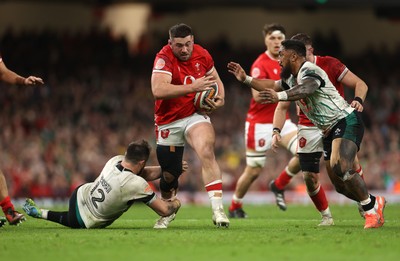 220225 - Wales v Ireland - Guinness 6 Nations Championship - Gareth Thomas of Wales is tackled by Robbie Henshaw and Bundee Aki of Ireland 