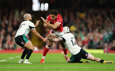 220225  Wales v Ireland, 2025 Guinness Six Nations - Ben Thomas of Wales takes on Mack Hansen of Ireland and Jamison Gibson-Park of Ireland