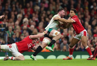 220225  Wales v Ireland, 2025 Guinness Six Nations - Tommy Reffell of Wales and Ben Thomas of Wales tackle Jack Conan of Ireland