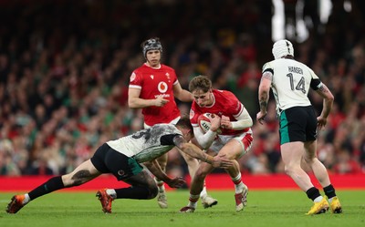 220225  Wales v Ireland, 2025 Guinness Six Nations - Ellis Mee of Wales takes on Garry Ringrose of Ireland and Mack Hansen of Ireland