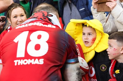 220225  Wales v Ireland, 2025 Guinness Six Nations - Henry Thomas of Wales signs autographs at the end of the match