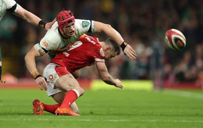 220225  Wales v Ireland, 2025 Guinness Six Nations - Josh van der Flier of Ireland loses the ball as he goes over Tomos Williams of Wales