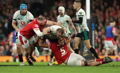 220225  Wales v Ireland, 2025 Guinness Six Nations - Finlay Bealham of Ireland is tackled by Dafydd Jenkins of Wales and Henry Thomas of Wales