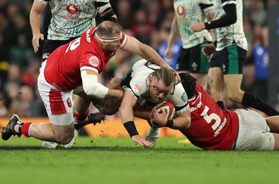 220225  Wales v Ireland, 2025 Guinness Six Nations - Finlay Bealham of Ireland is tackled by Dafydd Jenkins of Wales and Henry Thomas of Wales