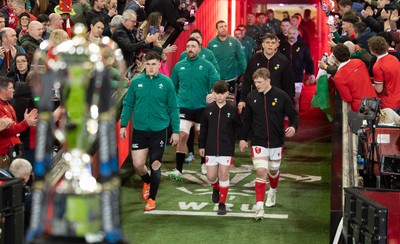 220225  Wales v Ireland, 2025 Guinness Six Nations - Dan Sheehan of Ireland and Jac Morgan of Wales with match mascot