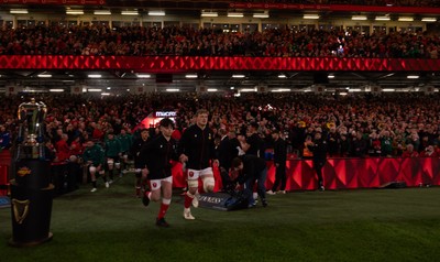 220225  Wales v Ireland, 2025 Guinness Six Nations - Jac Morgan of Wales runs out with match mascot George Rogers